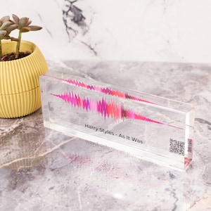 May include: A clear acrylic block with a pink and red sound wave graphic inside. The text "Harry Styles - As It Was" is printed below the graphic.