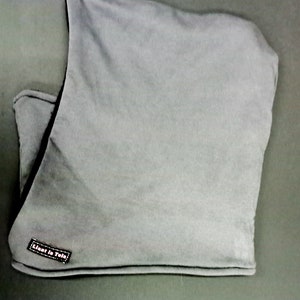 May include: Gray hooded neck warmer with a black trim and a small black label that reads "Lient & Tela".
