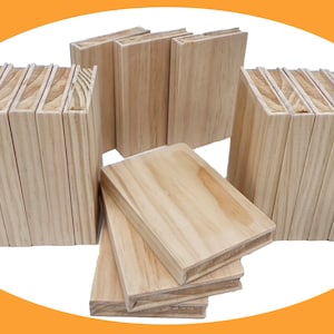 May include: A stack of 12 unfinished wooden boards, each approximately 1/2 inch thick, with a smooth surface and a natural wood grain. The boards are stacked in two groups of six, with one group lying flat on its side.