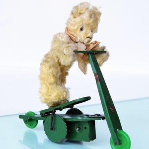 Antique Clokwork Toy by Wind-up Bear on Scooter