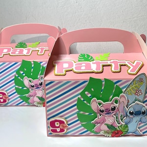 May include: Two pink party favor boxes with handles. Each box features a pink top with the word "Party" in gold glitter letters. The boxes have a blue, pink, and white striped pattern. The boxes are decorated with cartoon characters and the number 9.