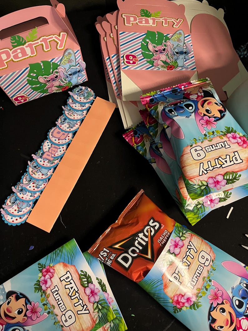 May include: A collection of party favors featuring a blue cartoon character with large ears. The favors include small boxes, bags, and cupcake toppers. The boxes and bags are decorated with a tropical theme and the text "Party Turns 9". The cupcake toppers are blue and white with the same cartoon character.