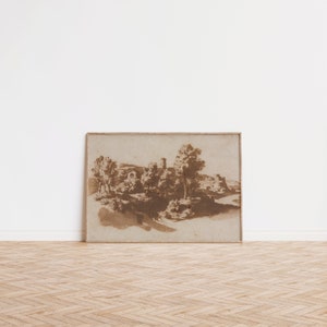 K&ouml;nnte beinhalten: Ein gerahmter Sepia-Landschaftsdruck. Das Kunstwerk zeigt eine detaillierte Szene mit B&auml;umen, Geb&auml;uden und einem Gew&auml;sser. Der Druck befindet sich in einem hellbraunen Holzrahmen, vor einer wei&szlig;en Wand und einem Holzboden.