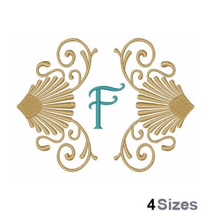 May include: A gold monogram design with a teal letter F in the center. The design features ornate swirls and a shell-like pattern on either side.