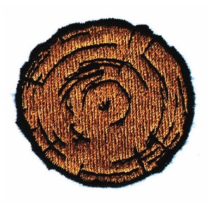 May include: A close-up of a brown embroidered patch depicting a tree trunk cross-section with visible growth rings.