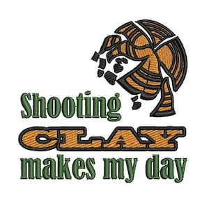 May include: Green and orange embroidery design with the text "Shooting Clay makes my day". The design features a stylised clay pigeon.