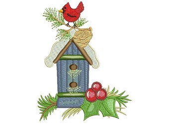 May include: A blue birdhouse with a red cardinal perched on top. The birdhouse has a green roof and a white snow-covered base. There are red berries and green holly leaves on the bottom.
