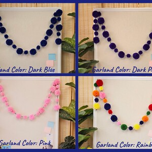 May include: Four pom-pom garlands in different colors: dark blue, dark purple, pink, and rainbow. Each garland is hanging on a white board with a light blue background.