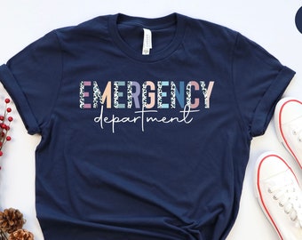 May include: A navy blue t-shirt with the text "EMERGENCY department" in colorful letters with a leopard print pattern.