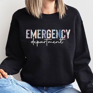 May include: Black sweatshirt with the text "EMERGENCY department" in colorful letters with a leopard print pattern.
