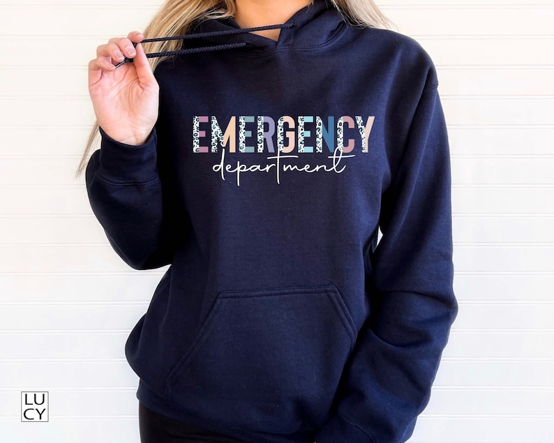 May include: Navy blue hooded sweatshirt with the text "EMERGENCY department" in colorful letters with a leopard print pattern.