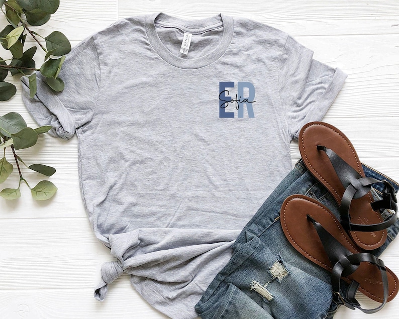 May include: A gray t-shirt with a blue and white graphic that says "ER Sofia".