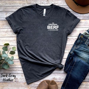 May include: Dark gray heather t-shirt with the text "The Original Berf of Chicagoland" printed on the front.
