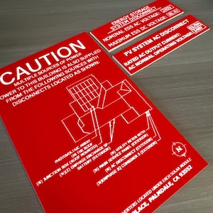 May include: Red and white caution sign with a diagram of a photovoltaic system, including a junction box, battery, utility meter, and combiner. The sign reads "CAUTION: Multiple sources of power...", "Energy Storage System Disconnect", "Nominal ESS AC Voltage: 240V", "Maximum ESS DC Voltage: 86.4V", "PV System AC Disconnect", "Rated AC Output Current: 53.78A", "AC Normal Operating Voltage: 240V", and "Microinverters located under each solar module, Once Place, Palmdale, CA 93552."