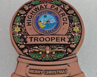 Moneda conmemorativa navideña de la Patrulla de Carreteras de Florida de 2026 (5,7 cm, 3 peniques). Solo se fabricaron 100 unidades.