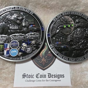 May include: Two circular metal challenge coins featuring detailed relief designs. The left coin depicts a wolf in police gear with text reading NIGHTSHIFT IS FUELED BY, CAFFEINE, NICOTINE, ADRENALINE, and FIND OUT. The right coin shows a skull and wolf with WE SEE WHAT OTHERS CAN'T and WE HUNT THE EVIL THAT LURKS WHILE YOU SLEEP.
