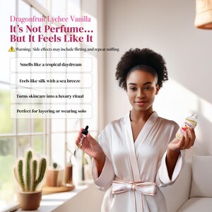 May include: A woman in a white satin robe holds a dropper and a bottle of Dragonfruit Lychee Vanilla. The text on the bottle and in the image reads "It's Not Perfume... But It Feels Like It". The image also includes a cactus in a pot.