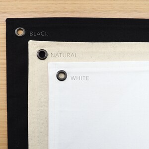 May include: Three fabric swatches with grommets, labeled "BLACK", "NATURAL", and "WHITE".