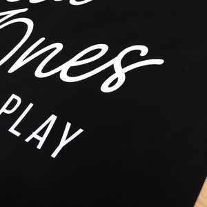 May include: Black tote bag with white text that reads "Good Ones Play".
