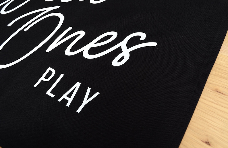 May include: Black tote bag with white text that reads "Good Ones Play".