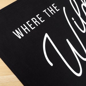 May include: Black canvas banner with white text that reads "Where the Wild Things Are".