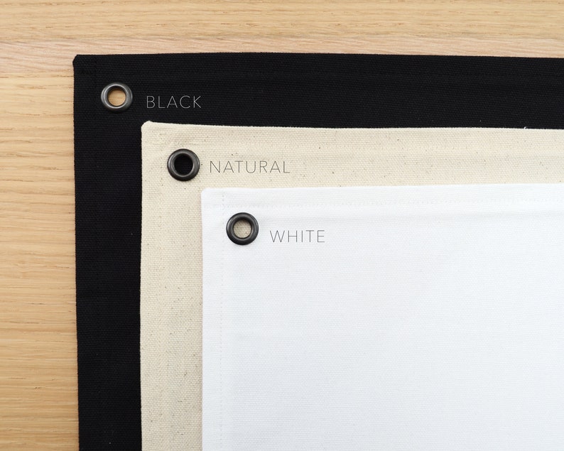 May include: Three fabric swatches with grommets, labeled "BLACK", "NATURAL", and "WHITE".