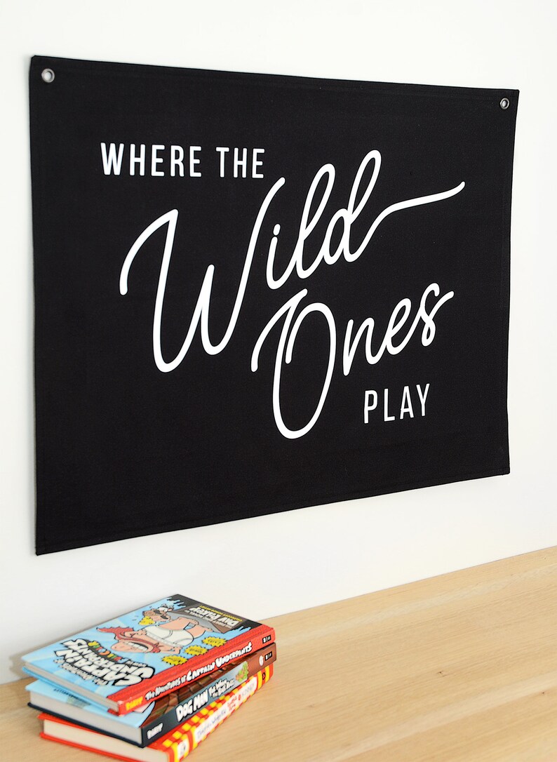 May include: Black canvas banner with white text that reads "Where the Wild Ones Play".