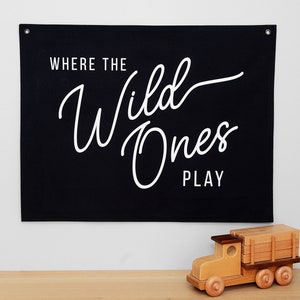 May include: Black canvas wall banner with white text that reads "Where the Wild Ones Play".