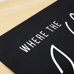 May include: Black canvas banner with white text that reads "Where the Wild Things Are".