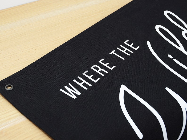 May include: Black canvas banner with white text that reads "Where the Wild Things Are".