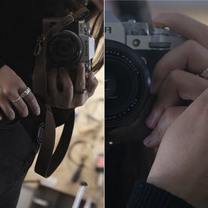 May include: Close-up of hands wearing various silver rings. The rings have different textures and designs, including a textured band, a hammered metal ring, and a delicate, wavy ring. The person is holding a camera.