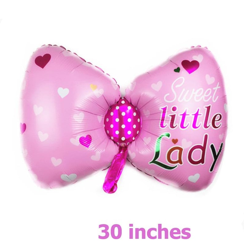 May include: Pink and white balloon shaped like a bow with a pink polka dot center. The balloon has the text "Sweet little Lady" printed on it. The balloon is 30 inches.