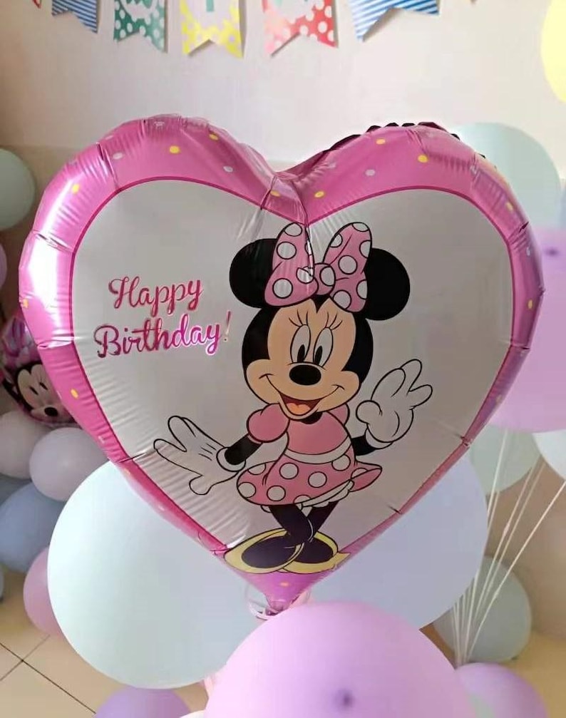 May include: A pink heart-shaped balloon with a Minnie Mouse character and the text "Happy Birthday!" printed on it. The balloon is surrounded by other balloons in various colors.