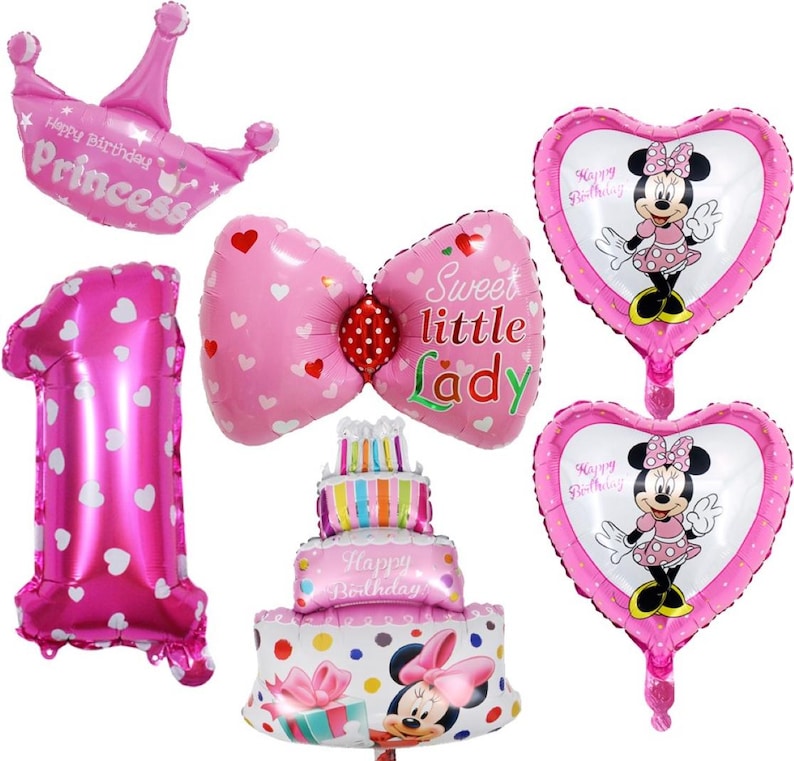 May include: A collection of pink foil balloons for a birthday celebration. Includes a crown, a number one, a bow, two heart-shaped balloons with Minnie Mouse, and a cake-shaped balloon. The balloons have text that says "Happy Birthday Princess" and "Sweet little Lady".
