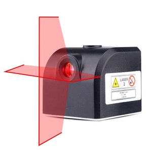 May include: A black laser level with a red laser beam projecting out of it. The laser level has a warning label that says "Laser 2" and "EN 60825-1:2014 P < 1 mW λ = 635 nm".