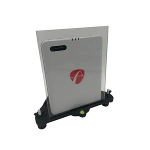 May include: A white device with the text "Face Tracking" and a red "f" logo, held in a clear plastic frame and mounted on a black base with a spirit level. The device has three small, raised lines.