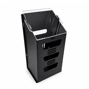 May include: A matte black vertical storage organizer featuring a slanted top opening with a clear acrylic guard. The front panel includes three horizontal rectangular cutouts with integrated ventilation slats, secured by visible screws at the corners.