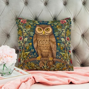 May include: A decorative throw pillow with a brown owl perched on a branch surrounded by colorful flowers and foliage on a dark blue background.