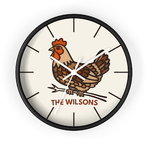 May include: A round wall clock with a black frame. The clock face is cream-colored and features a brown and tan illustration of a hen perched on a branch. The text "THE WILSONS" is below the hen.