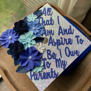 41 All That I Am Graduation Cap topper, Graduation Flower Cap Topper, Grad quote Graduation Cap, White and blue Glitter Grad Cap Active