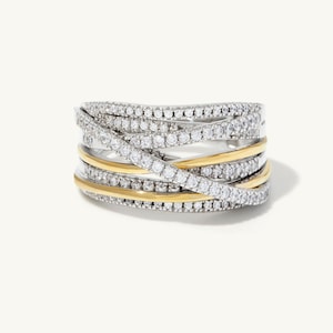 May include: A gold and silver ring with multiple bands set with small diamonds.