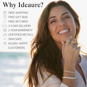 May include: A woman smiles while wearing a gold bracelet and two gold rings. The text "Why Ideaure?" is at the top of the image. Below the text is a list of benefits, including free shipping, free gift box, free returns, 2-4 day delivery, 2-year warranty, certified metals, skin safe, and 60,000+ happy customers.