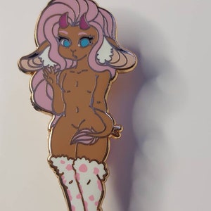 May include: A pink and brown cartoon character with horns, wearing white fuzzy socks with pink polka dots. The character has blue eyes and a surprised expression.