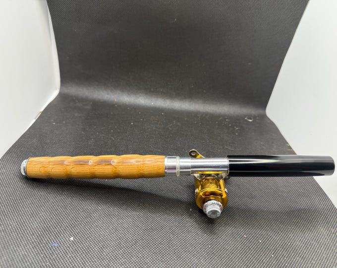 Pocket fishing pole with Tennessee whiskey barrel handle and black cap