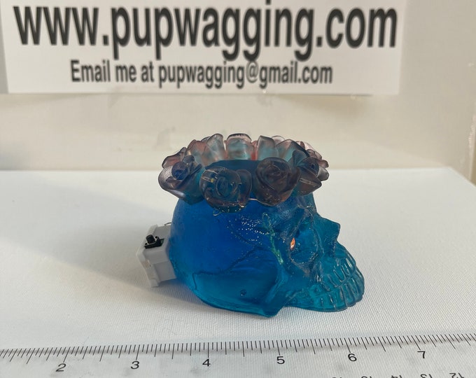 Skull with crown of roses on the head blue with red highlights and LED lights