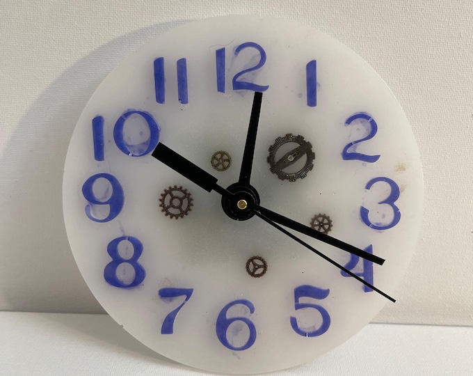 White acrylic clock with metallic blue number and metallic gears