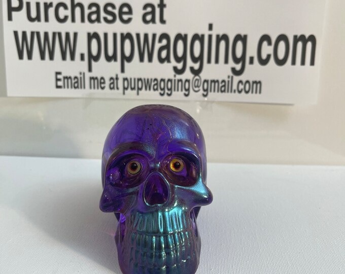 Purple skull with metallic highlights and LEDs lights throughout and a flower in the skull
