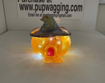 Pumpkin house jar with a witches hat lid with LED lights