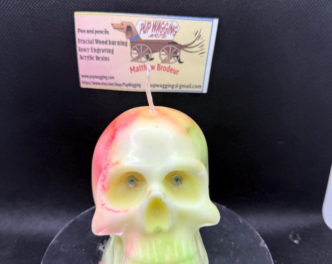 skull candle glow in the dark and green with a yellow base and citronella scent and blue eyes