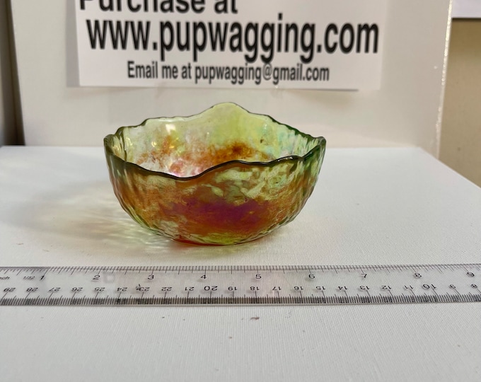 Green bowl with red leaf in the bottom